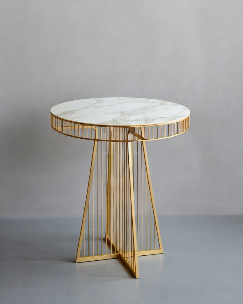 Round side table with marble top and gold metal frame on a gray background