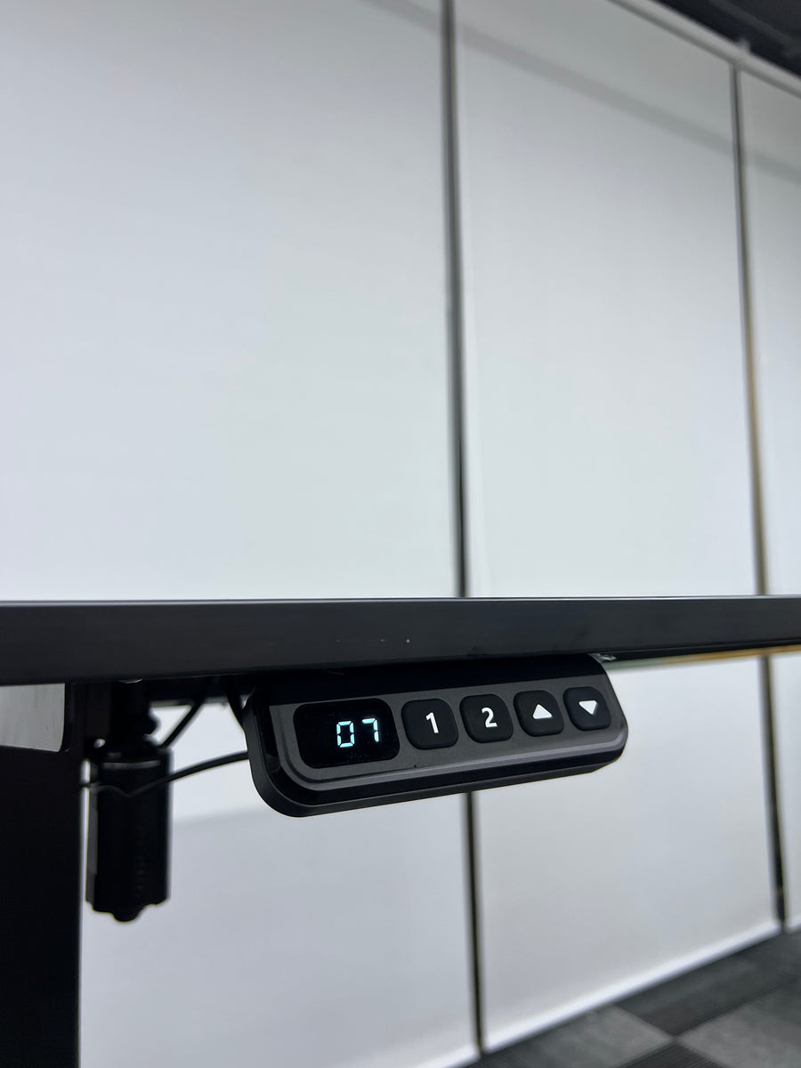 Control panel of a kitchen appliance with digital display and buttons on a tiled wall background