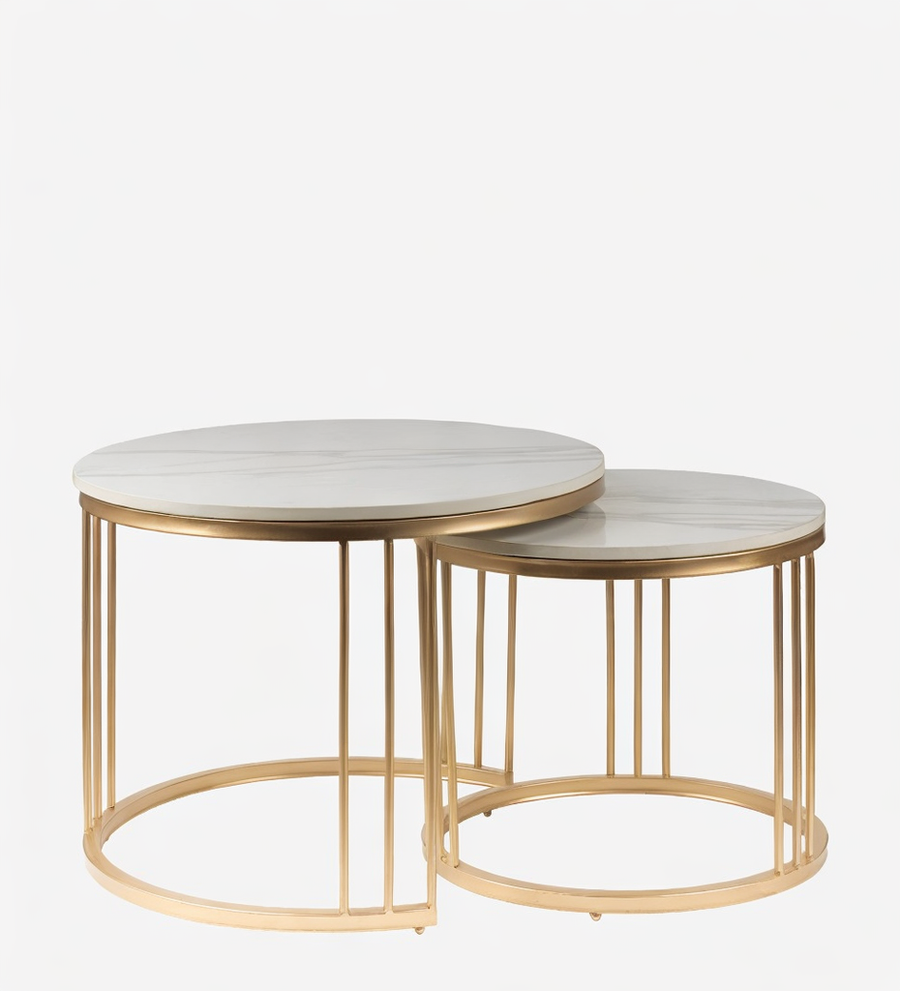 Set of two round marble top tables with gold metal frames on a white background