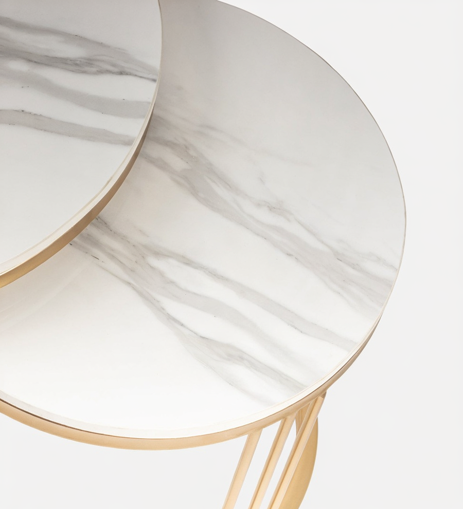 Close-up of a marble-patterned side table with gold accents on a light background